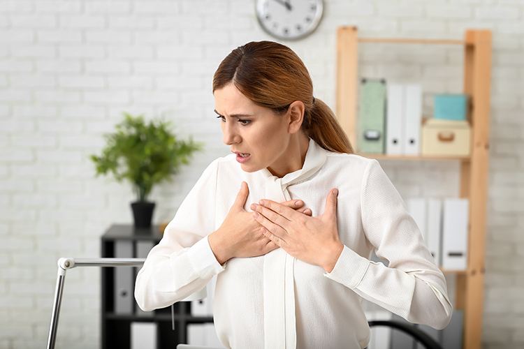 A person experiencing a hyperventilation attack, breathing rapidly with visible distress